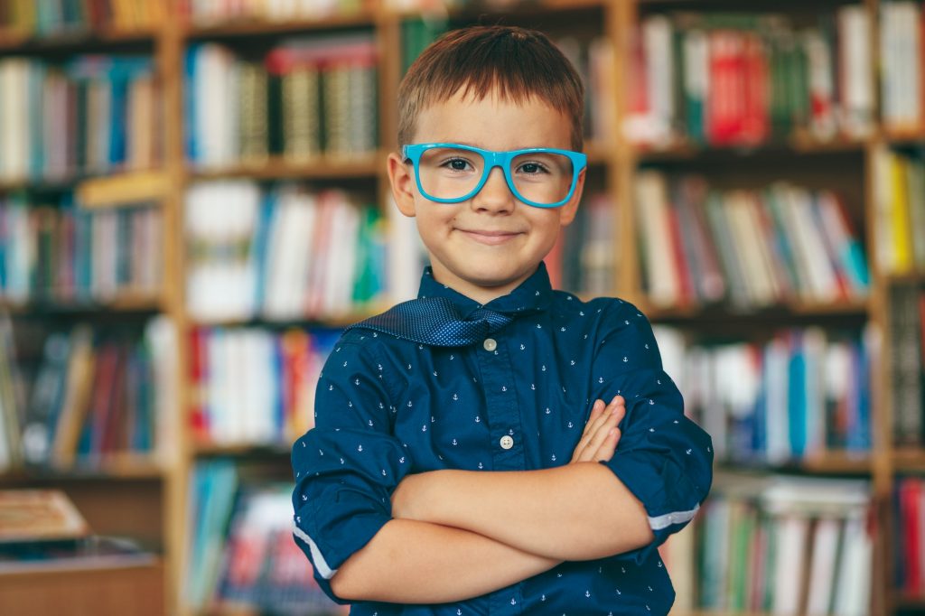 Boy with glasses in library